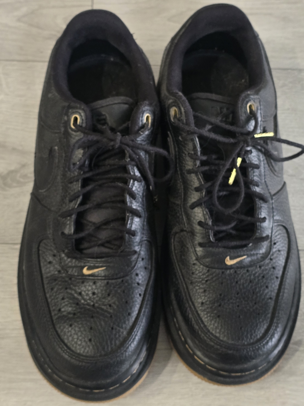 Nike Men’s Black Sneakers with Gold Swoosh